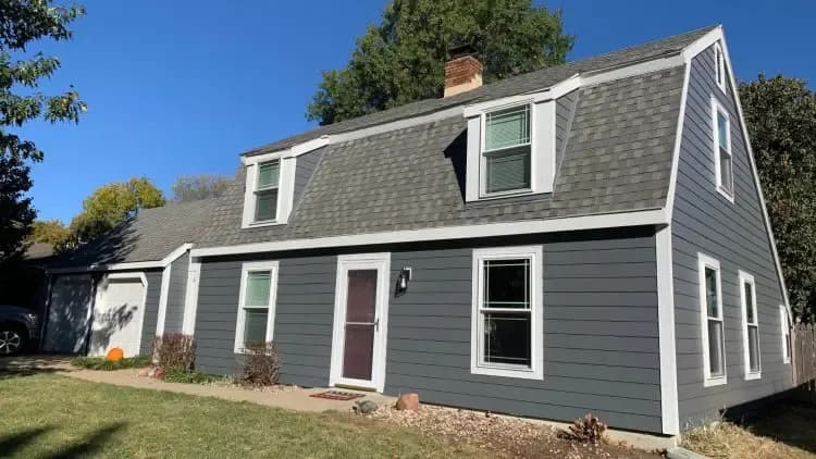 Safe Harbor Exteriors restores Lawrence, KS home with blue James Hardie Siding, windows and gutters