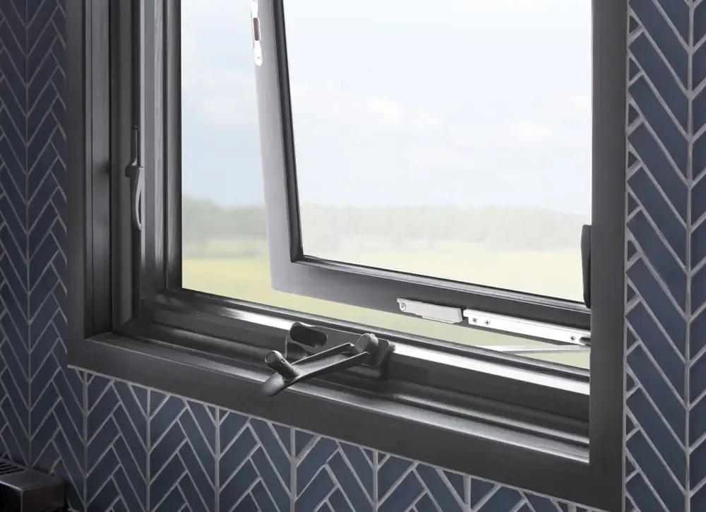 Awning Window with black trim in a tiled bathroom.