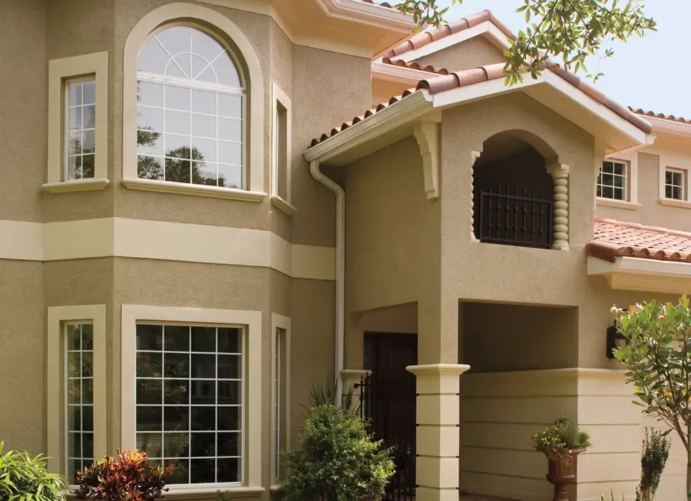 Bay and Bow Windows on a tan, Spanish-style house.