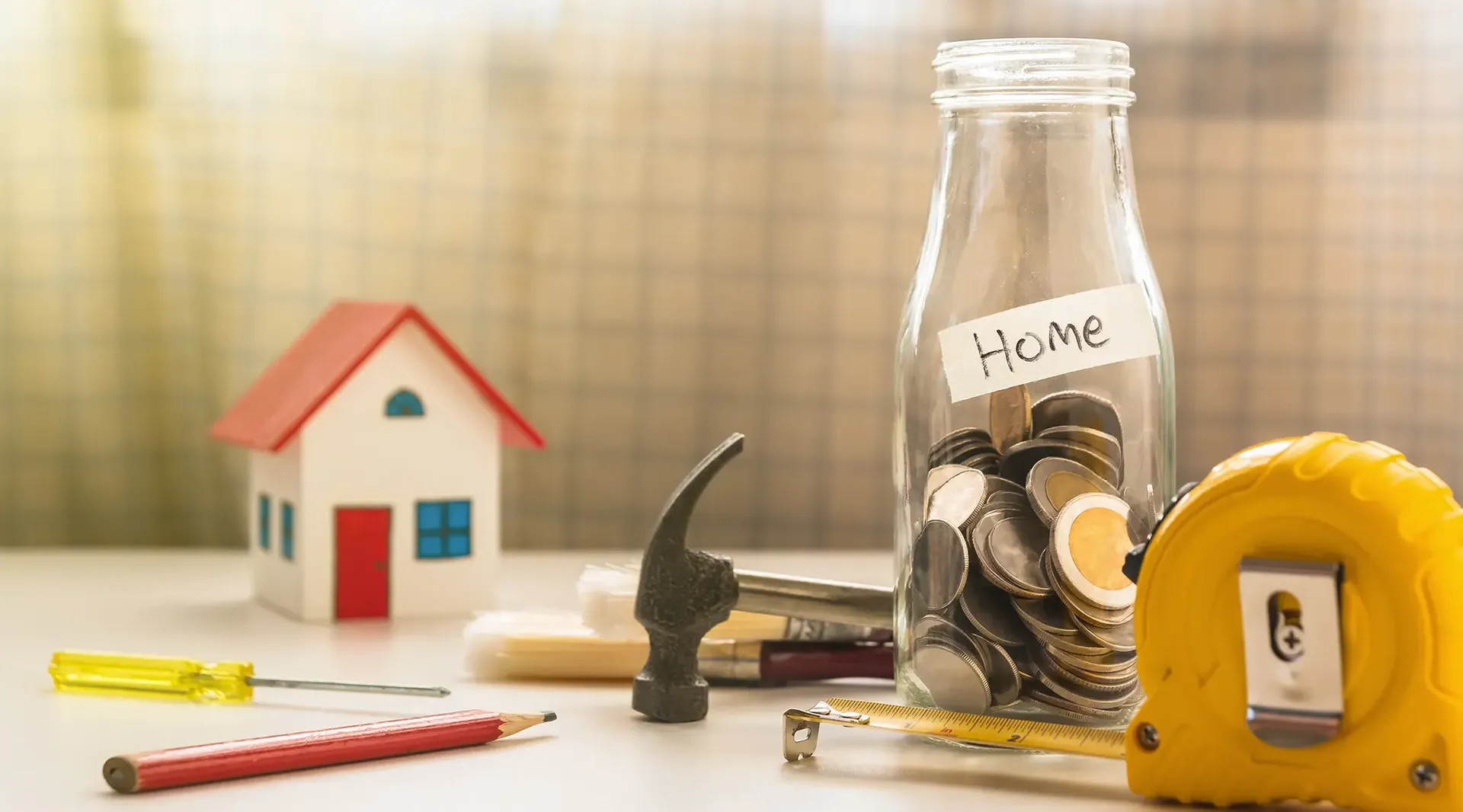 A jar full of change with a label on it that reads "Home".