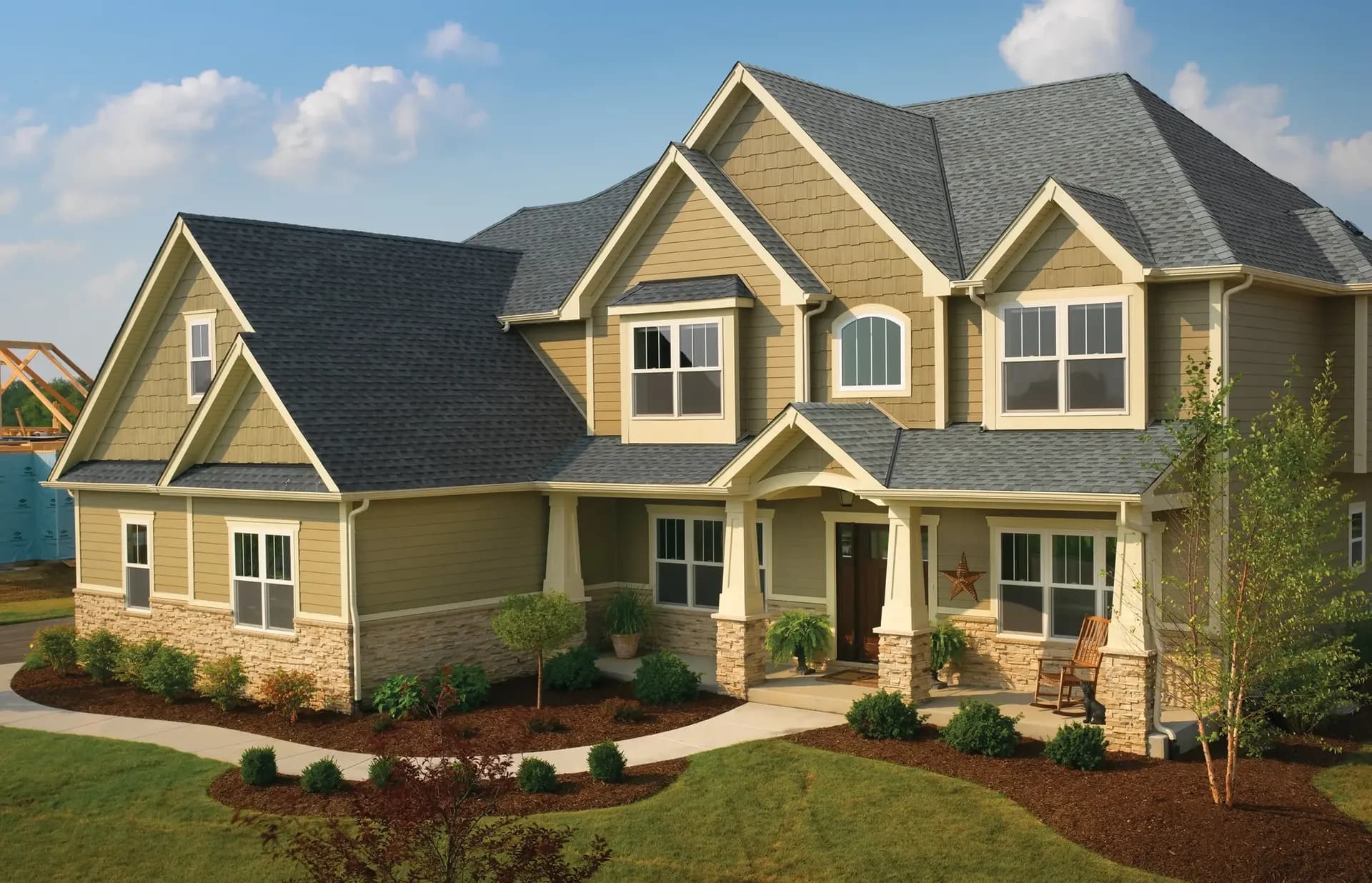 Newly-installed, gray GAF residential roofing on a tan house.