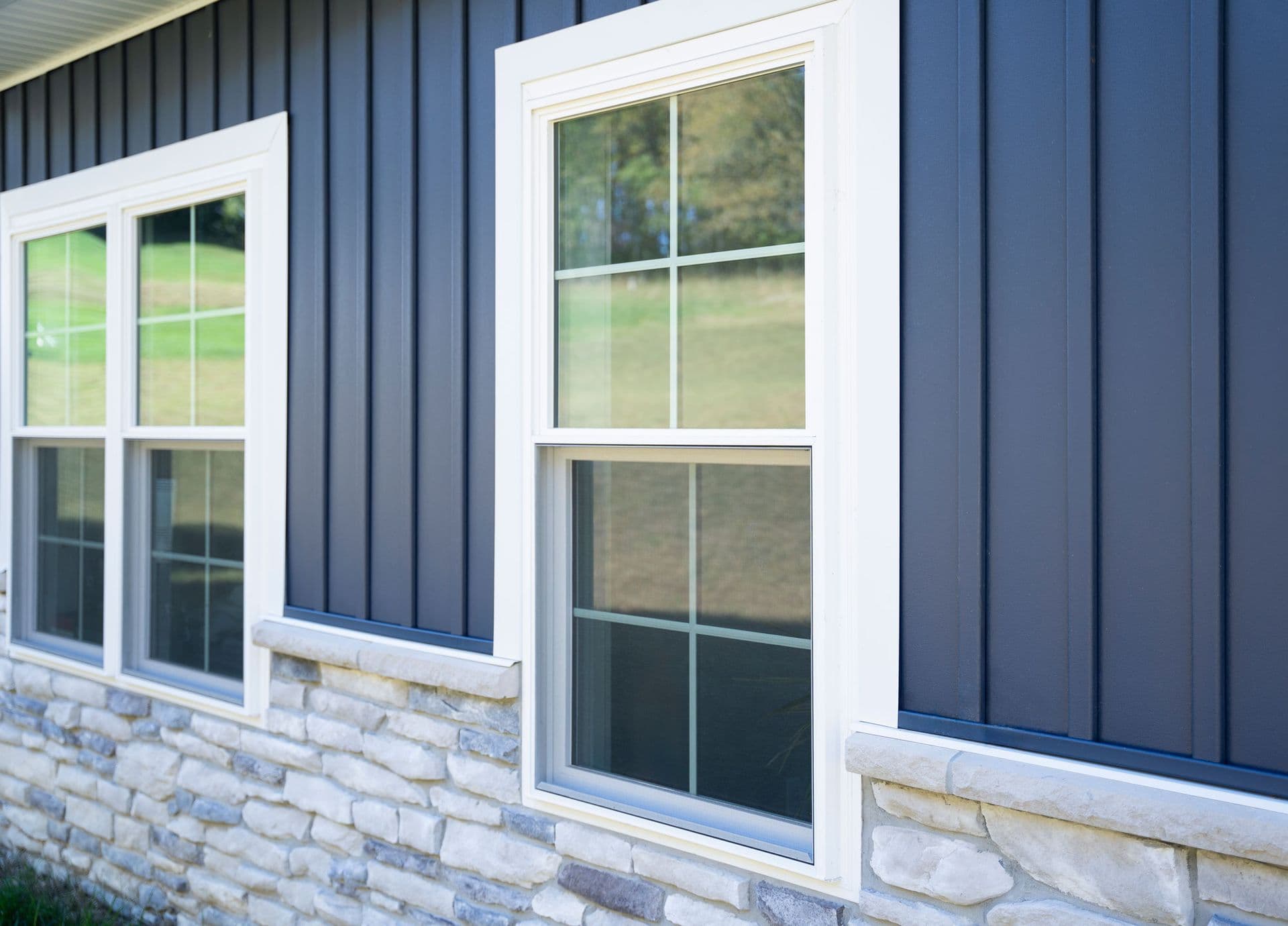 Exterior view of ProVia® Endure™ Double Hung Windows in White with contoured internal cottage grids.