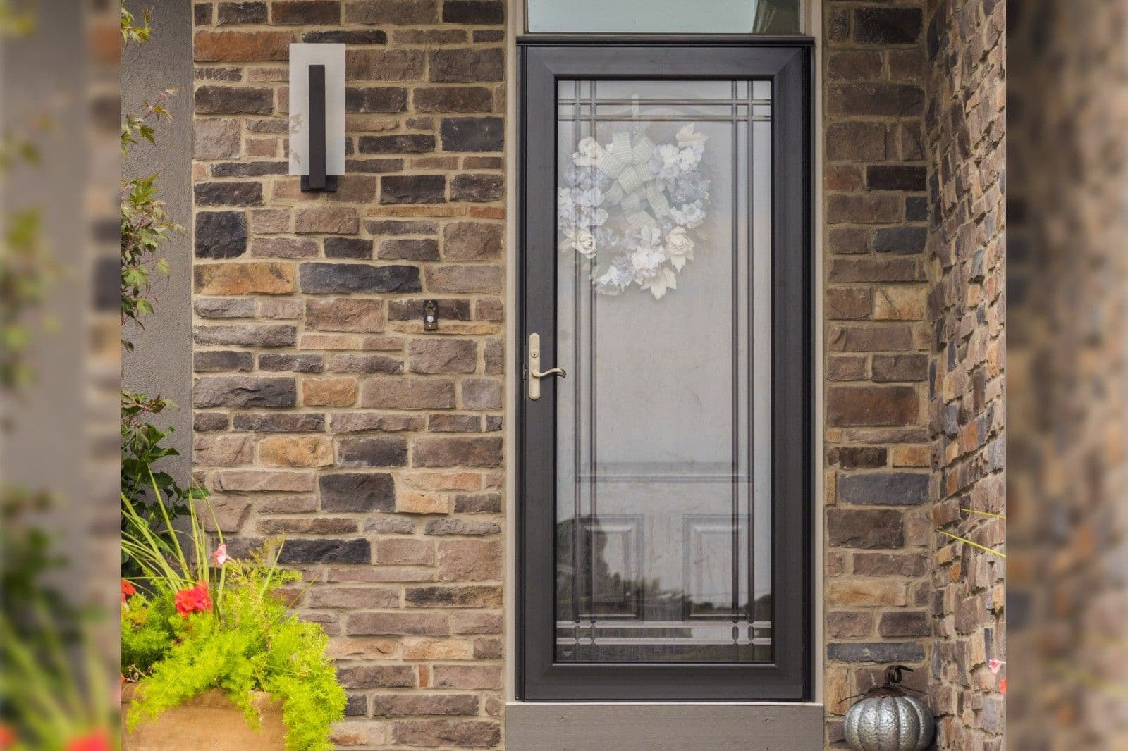 A ProVia front entry door on a house with a stone facade.