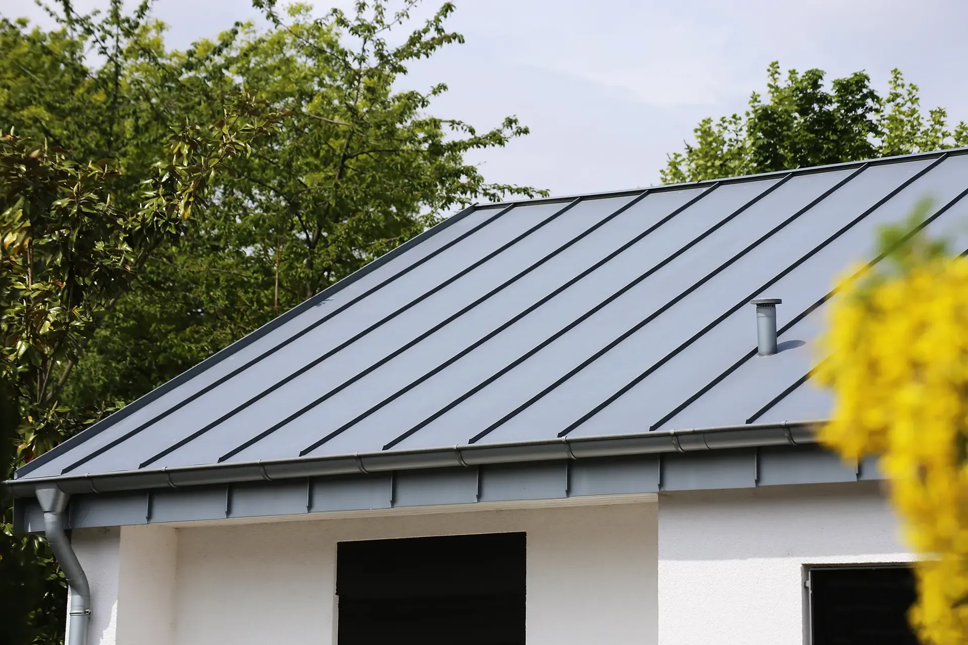 New gray Standing Seam Metal Roof on a Home.