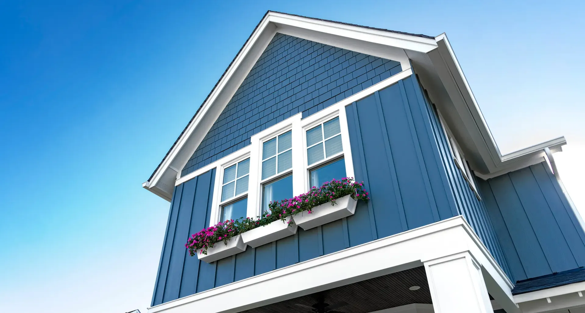 A blue and white house with combined vertical and lap James Hardie siding.