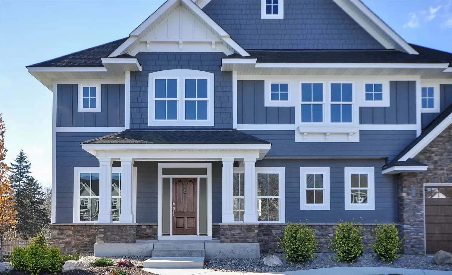 A blue and white house with three different styles of James Hardie siding.
