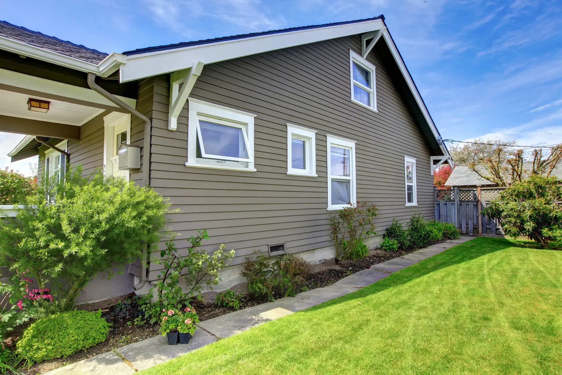 A blight brown house with new Siding in Kansas City.