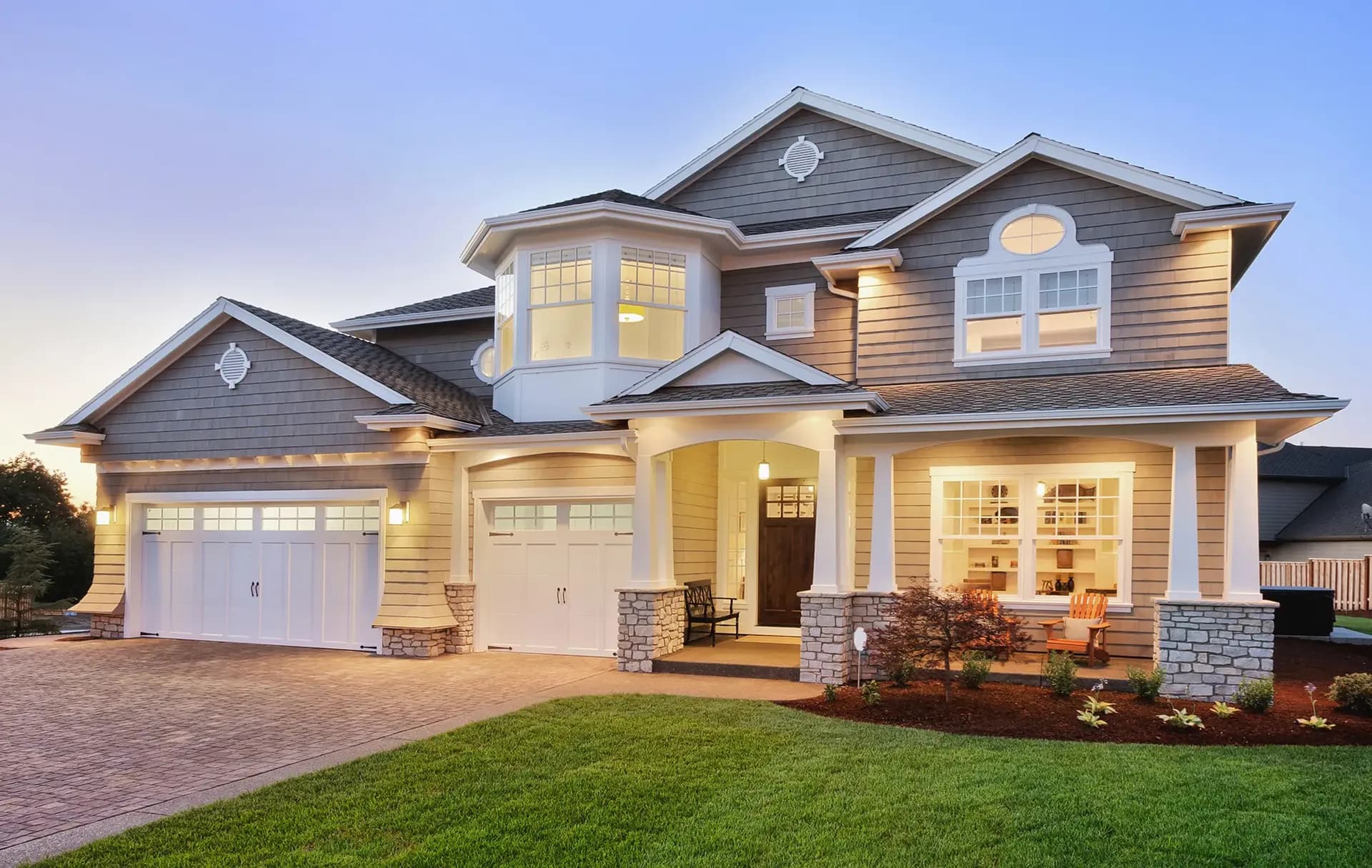 A gray house with white trim and newly-installed windows.